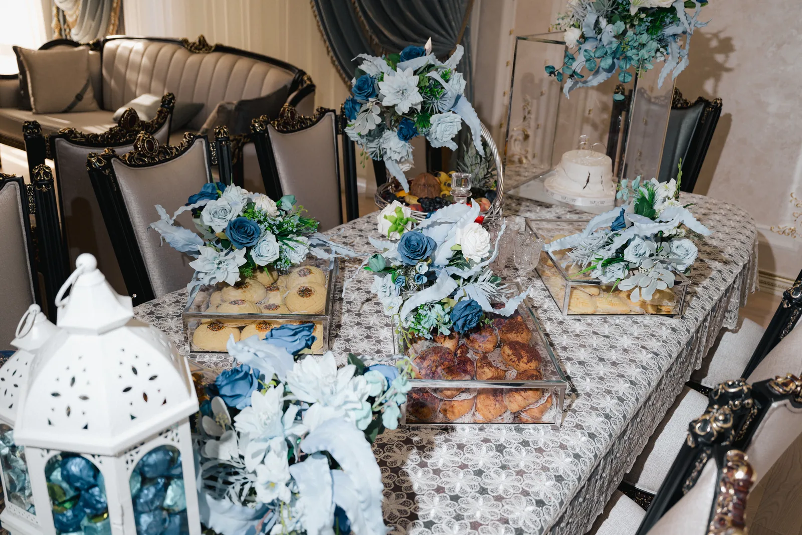 A wedding pastry table with blue and white flowers and lanterns (not at Borgo Egnazia)
