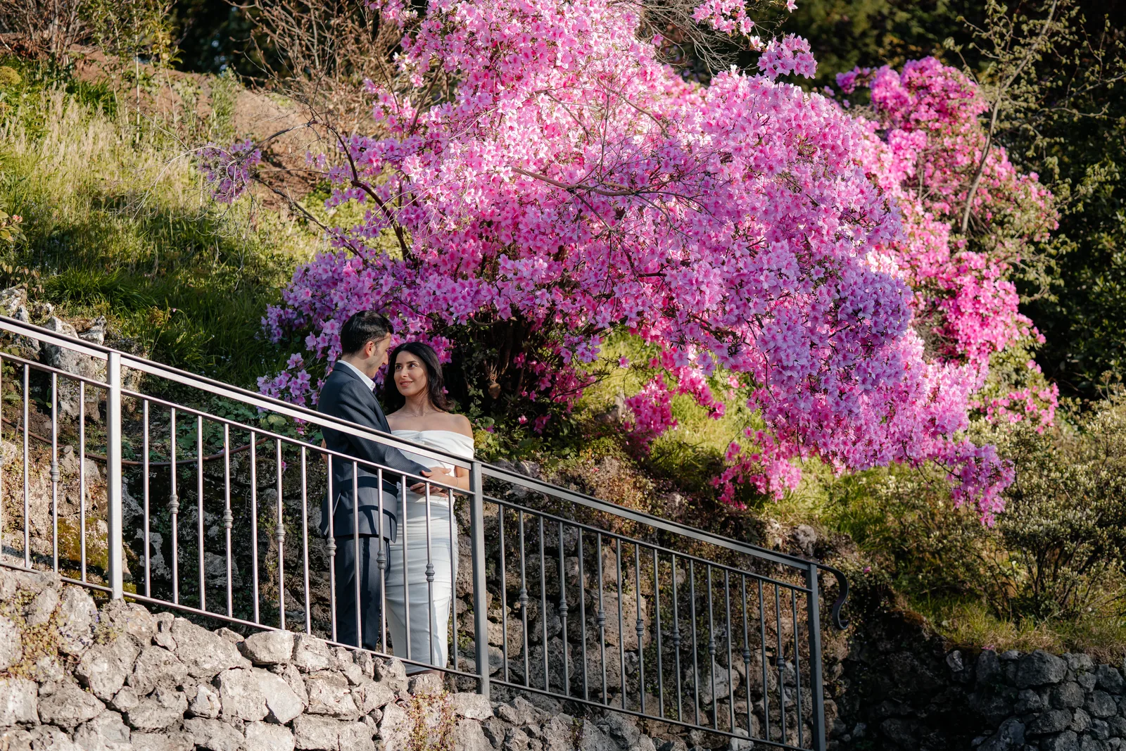 A couple on garden stairs lined with azaleas, elsewhere on Lake Como (not at Villa Cipressi)