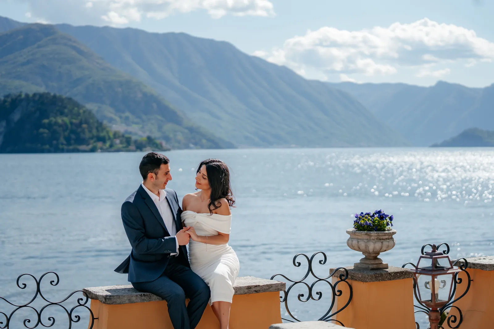 Ali and Zariyat on an ochre villa terrace above Lake Como during their engagement session