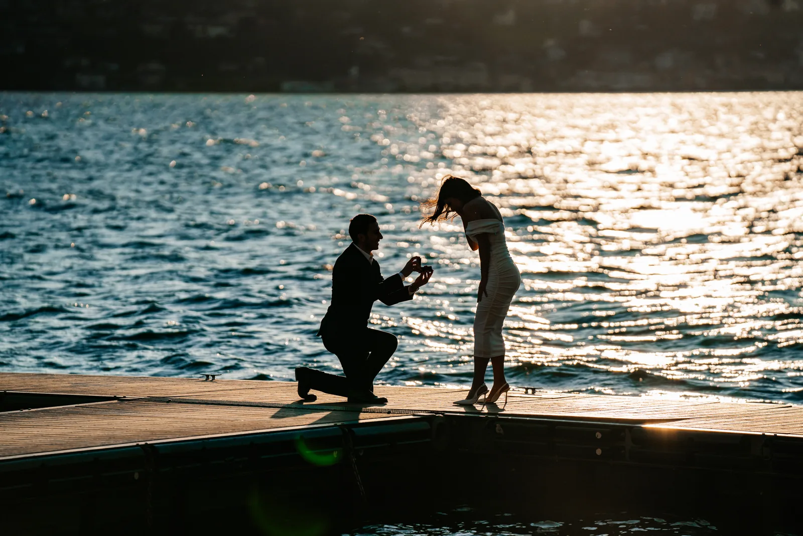 Two silhouettes against the glittering water of Lake Como (not at Villa del Balbianello)