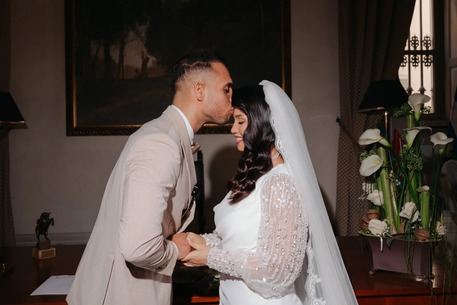 Mohammed kisses Hejrat on the forehead at their civil ceremony at the town hall