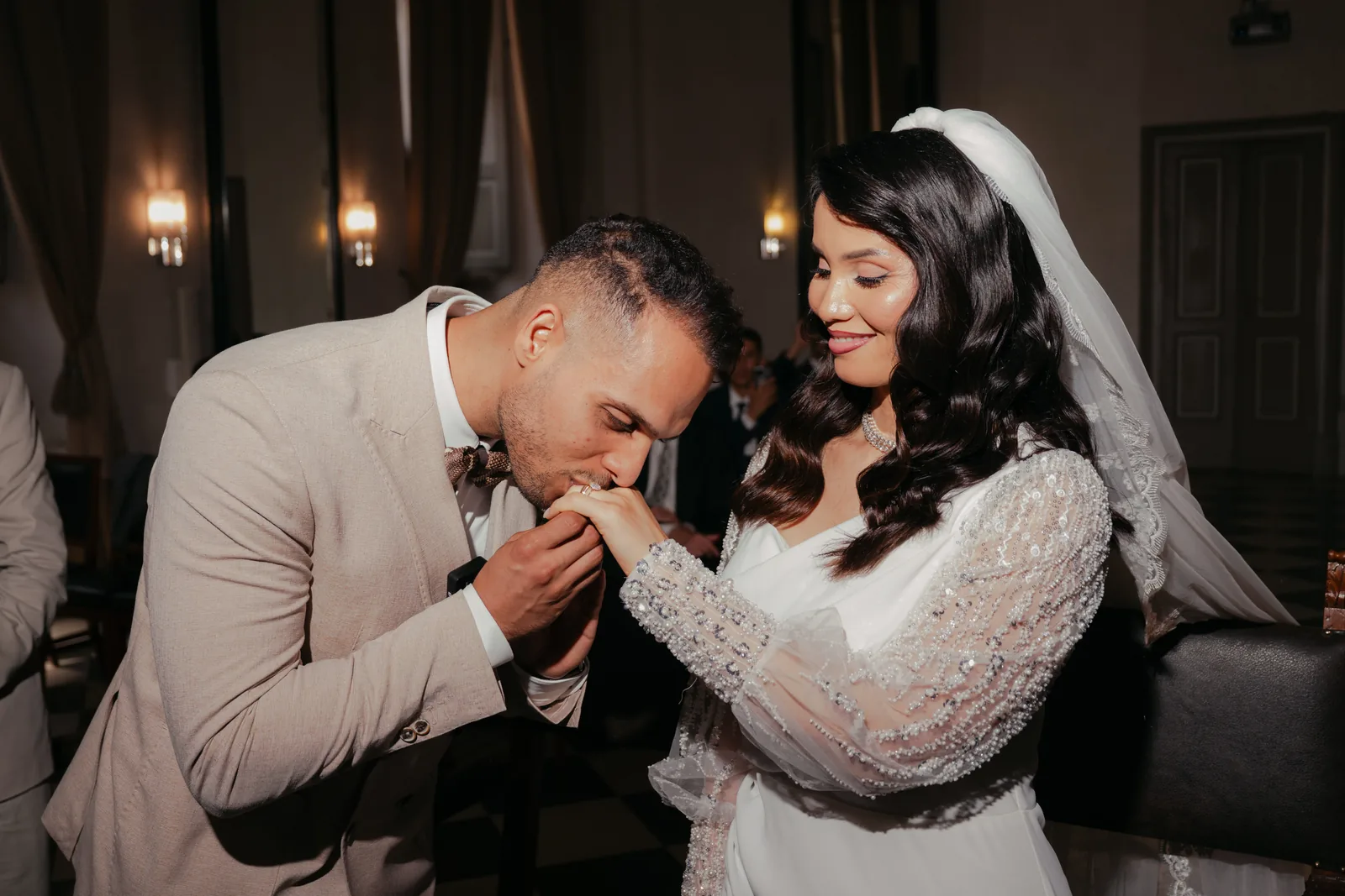 Mohammed bows to kiss Hejrat's hand at their civil ceremony at the town hall