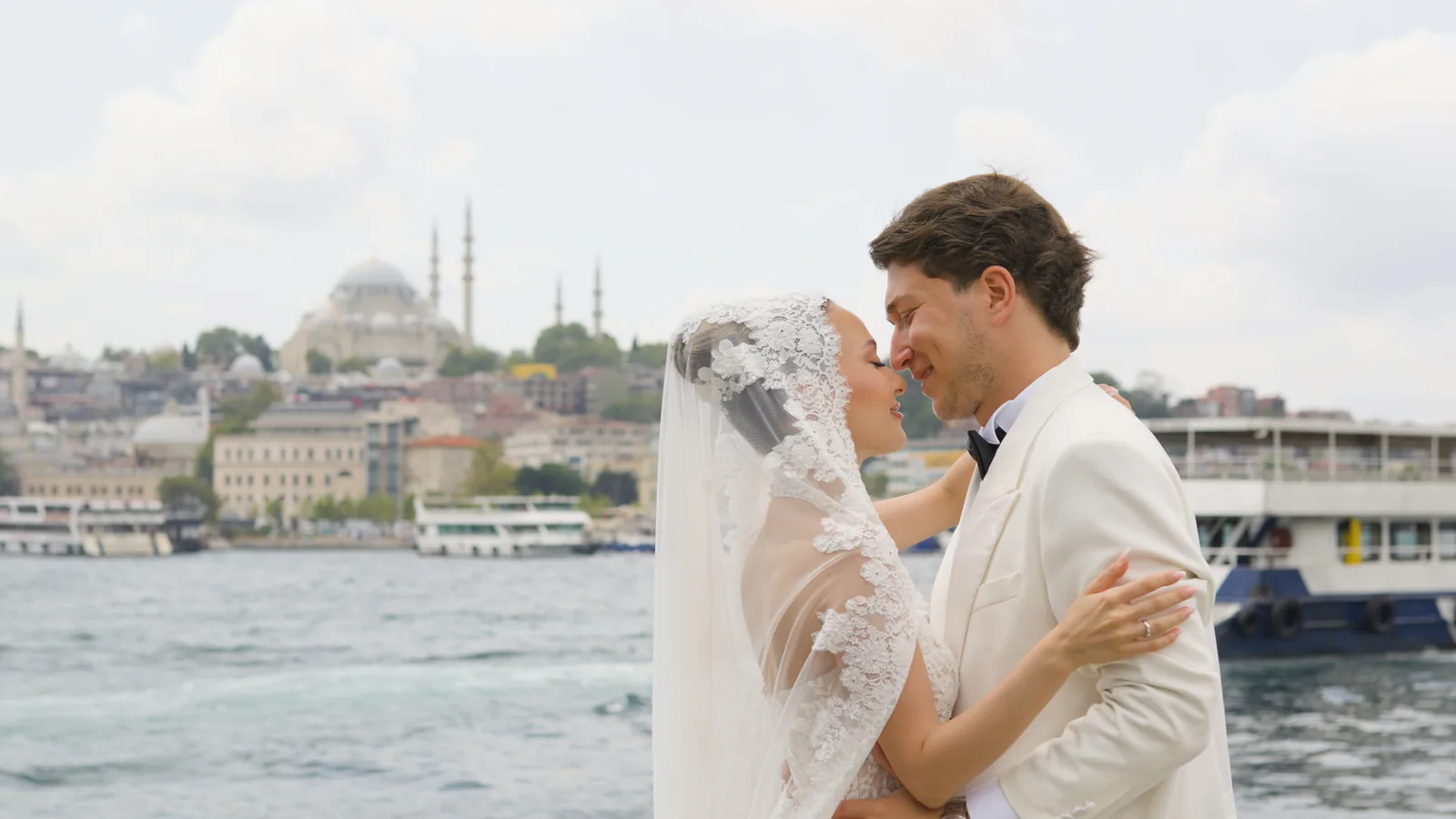 Gül and Oğuz smiling nose to nose in front of the Istanbul skyline