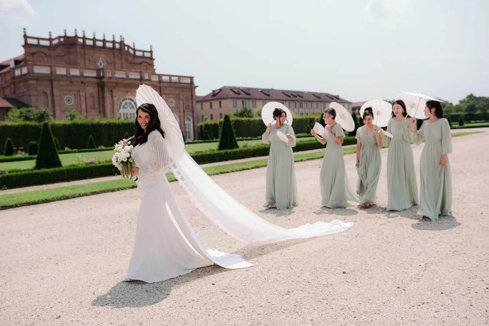 Hejrat with her bridesmaids in the gardens of the Reggia di Venaria, the palace behind them